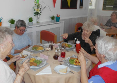 A group of Woodstock Residential Care Home residents having a fish & chip lunch