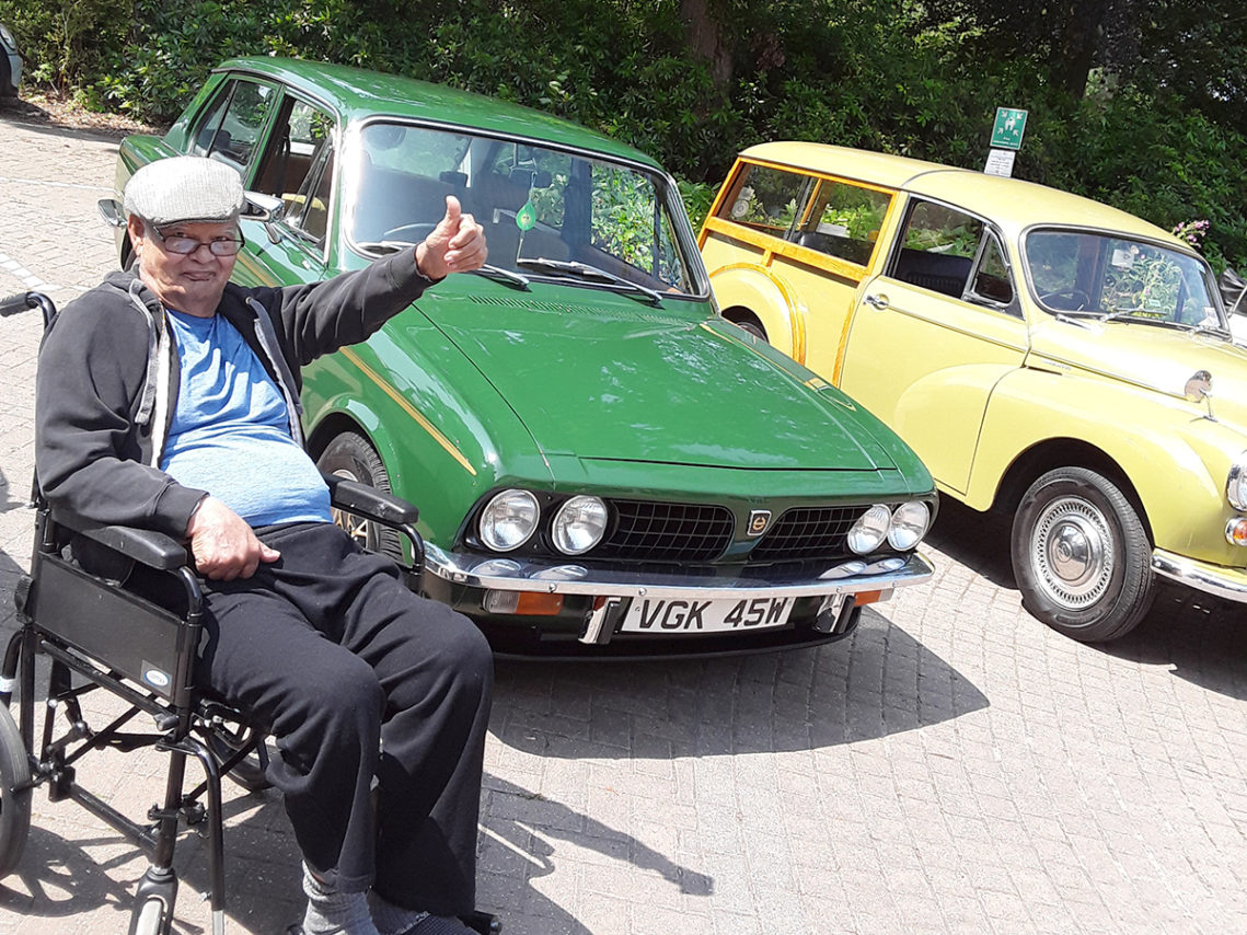 A male Abbotsleigh Care Home resident enjoying a display of Morris Minors outside the Home