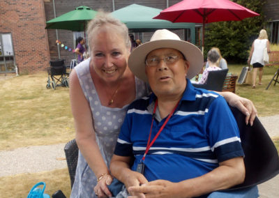 A resident and family member together in the garden at Hengist Field Care Home