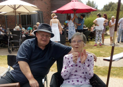 A resident and family member together in the garden at Hengist Field Care Home