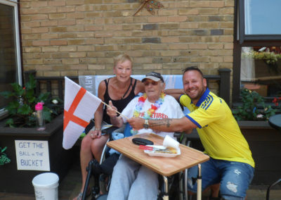 St Winifreds resident waving an England flag with his family
