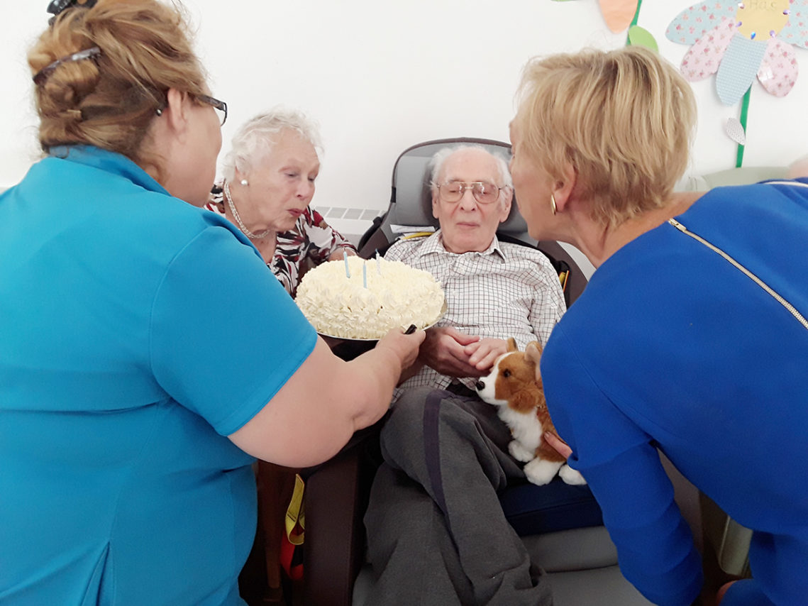 Abbotsleigh Care Home resident with birthday cake and family