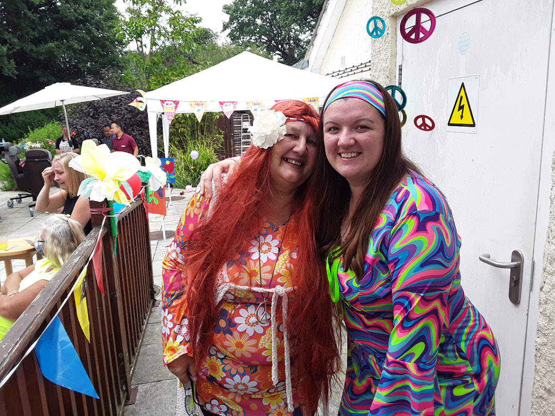 Two ladies dressed in 60s hippy clothes