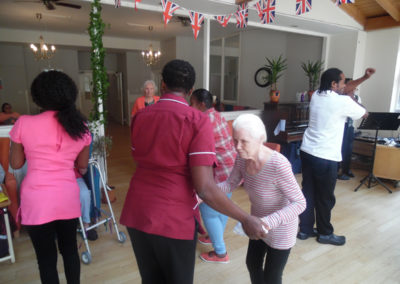 Care Home staff and residents dancing together to live music
