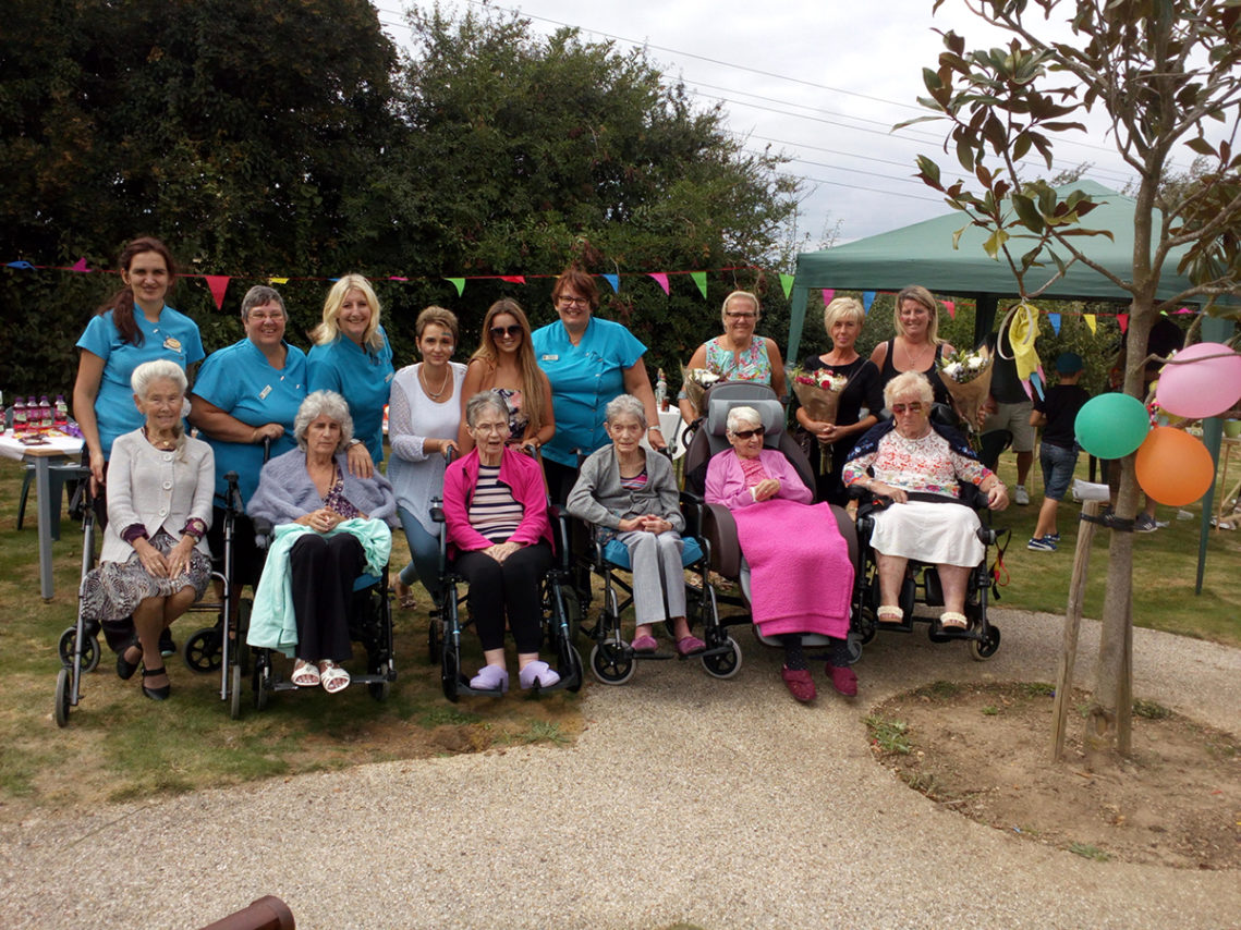Female residents and staff members outside in the garden at Hengist Field Care Home