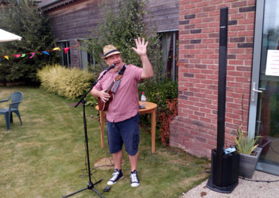 Entertainer Rob plays his Ukulele and sings for the crowds at Hengist Field Care Home