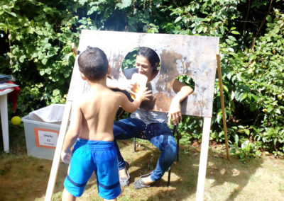 Loose Valley staff member getting soaked in the stocks to raise money during their summer fete 2018
