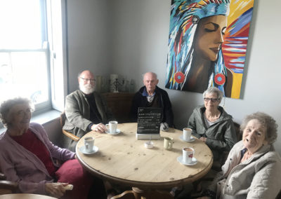 Residents and staff from Lulworth House having coffee in a cafe in Whistable