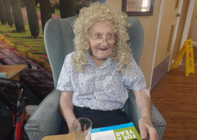 Princess Christian resident smiles as she wears a Dolly Martin wig