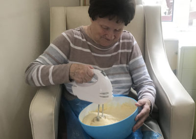 Lulworth resident using an electric whisk to stir cake mix
