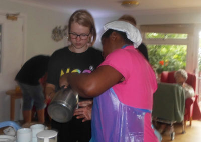 NCS teenagers helping to serve tea to Woodstock residents