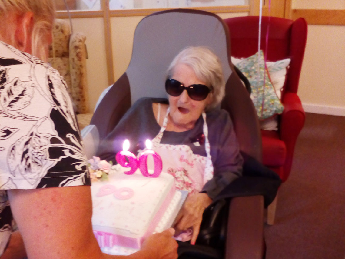 Female resident at Hengist Field Care Home being presented with a special cake for her 90th birthday