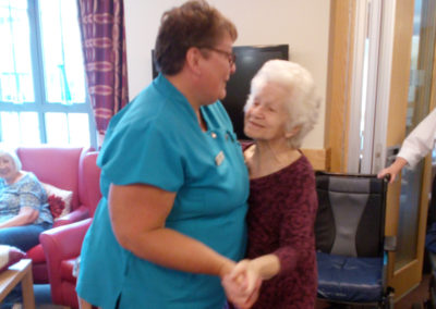 Staff member and resident at Hengist Field Care Home dancing to Storm King entertainer singing
