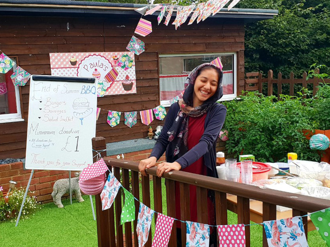 A member of staff in the garden at Lukestone Care Home, preparing for a BBQ