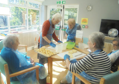 Residents at The Old Downs Residential Care Home working together to make cheesy sticks