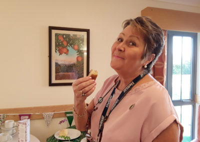 Viv Stead at Hengist Field Care Home having a piece of banana cake