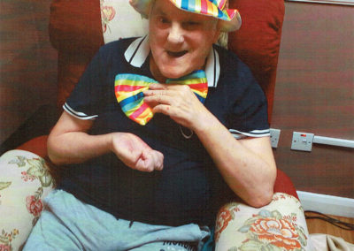 A Meyer House Care Home resident wearing a stylish matching hat and bow tie