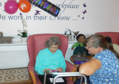 Female Woodstock resident opening birthday cards with a relative