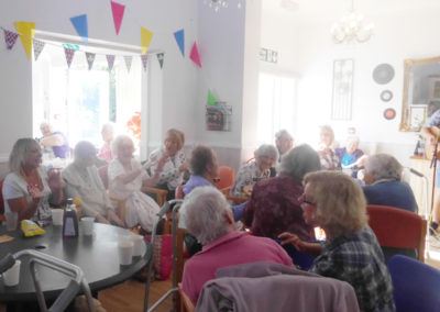 Woodstock Residential Care Home residents and guests enjoying a live entertainer