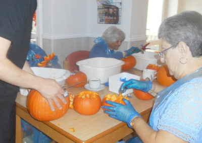 Residents enjoying carving pumpkins at Woodstock Residential Care Home