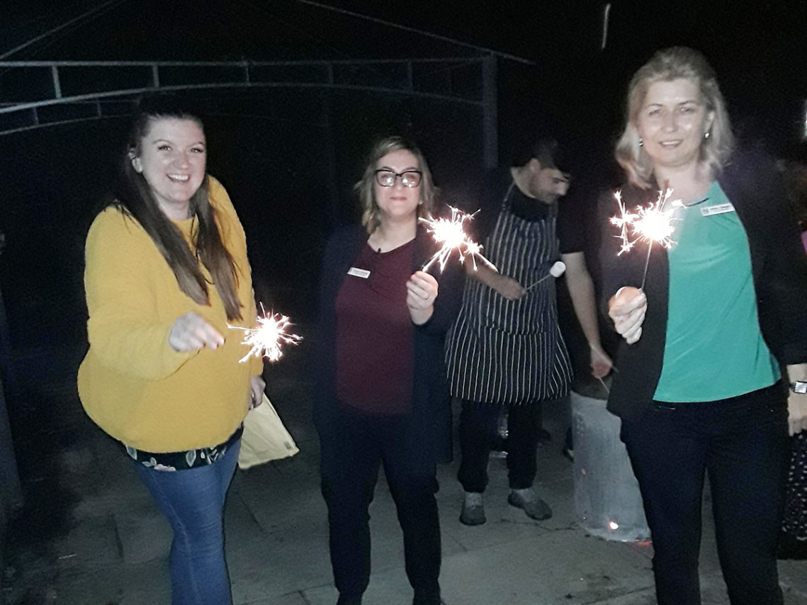 Staff and sparklers on bonfire night at Abbotsleigh Care Home
