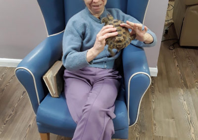 Abbotsleigh Care Home resident holding a tortoise