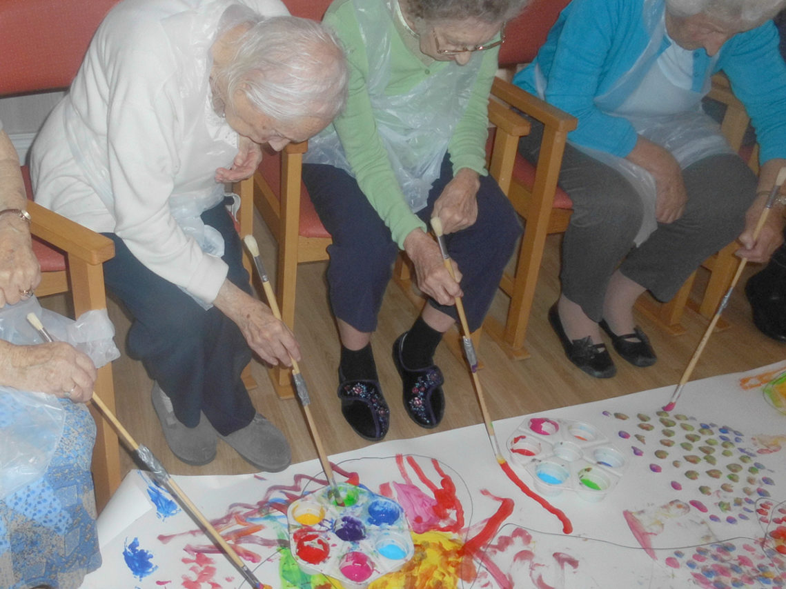 Resident at Woodstock Residential Care Home enjoyed painting with children from local nursery school