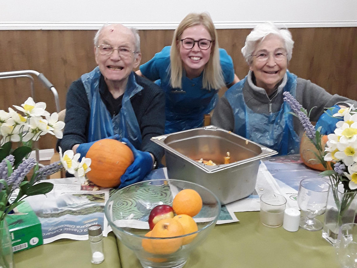 Residents enjoying carving pumpkins at Abbotsleigh Care Home