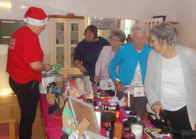 Woodstock Residential Care Home lady residents looking at Body Shop products brought into the Home