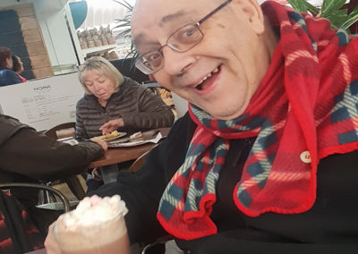 Lukestone Care Home male resident enjoying a hot chocolate at Polhill Garden Centre