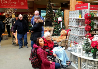 Lukestone Care Home residents looking at Christmas decorations in a garden centre