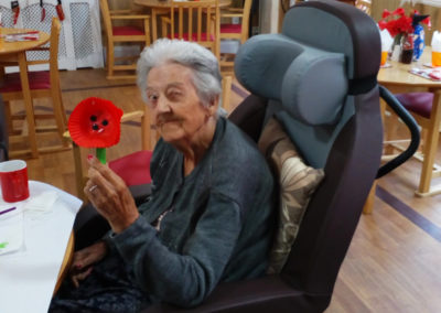 Meyer House resident making a Remembrance poppy