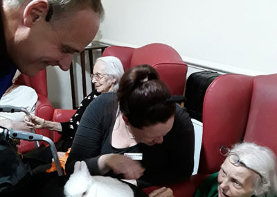Marco the Magician entertaining Lulworth house residents by making a rabbit appear from his hat
