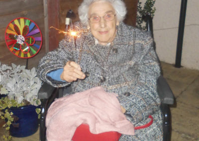 Woodstock resident smiling as she holds a sparkler