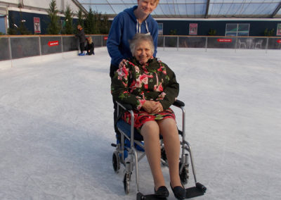 A resident and carer on the ice at Ruxley Manor Garden Centre's ice rink