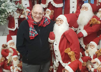 Lukestone Care Home gentleman resident by a display of Santas at Polhill Garden Centre