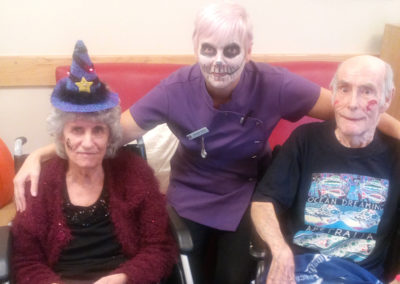 Hengist Field staff member and residents smile for a Halloween photo