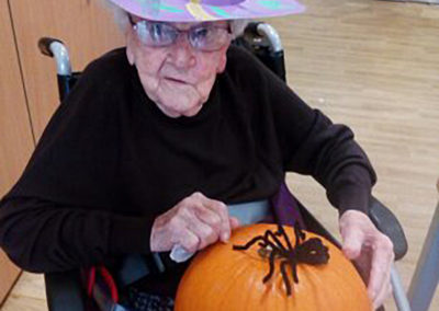 Hengist Field resident dressed as a witch with a pumpkin and a spider