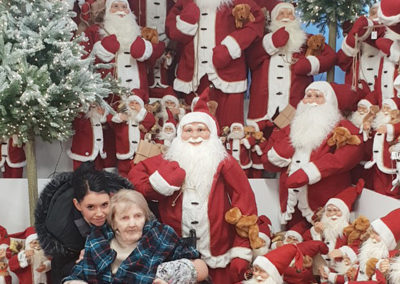 Lukestone Care Home resident by a display of Santas at Polhill Garden Centre