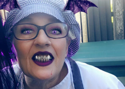 The Meyer House Chef with purple lipstick, vampire fangs and ears