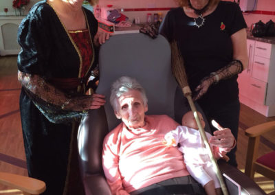 Two Meyer House staff dressed as witches with a resident