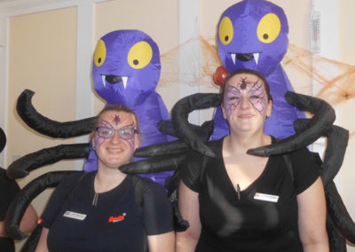 Two lady staff members from Woodstock Residential Care Home dressed in Halloween spider costumes