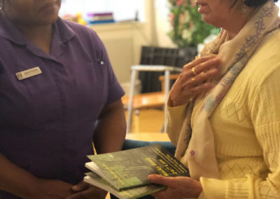 Author Sylvia Bryden-Stock presenting her books to a member of staff at Bromley Park Care Home