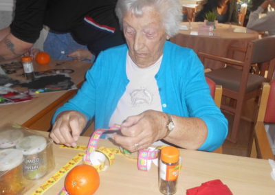 Woodstock Residential Care Home resident making a Christmassy pomander with an orange and cloves