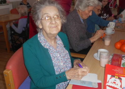 Woodstock Residential Care Home resident writing her Christmas cards