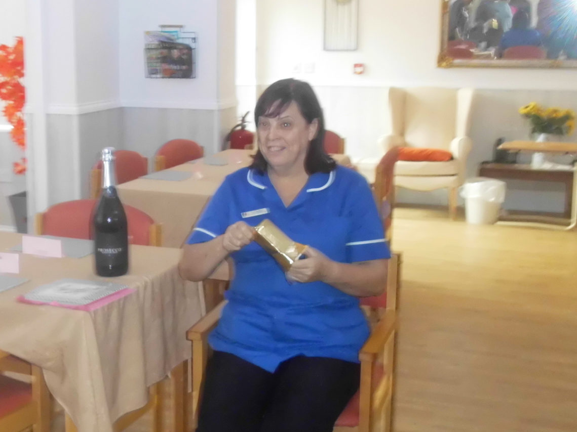 A member of staff at Woodstock Residential Care Home receiving some leaving presents