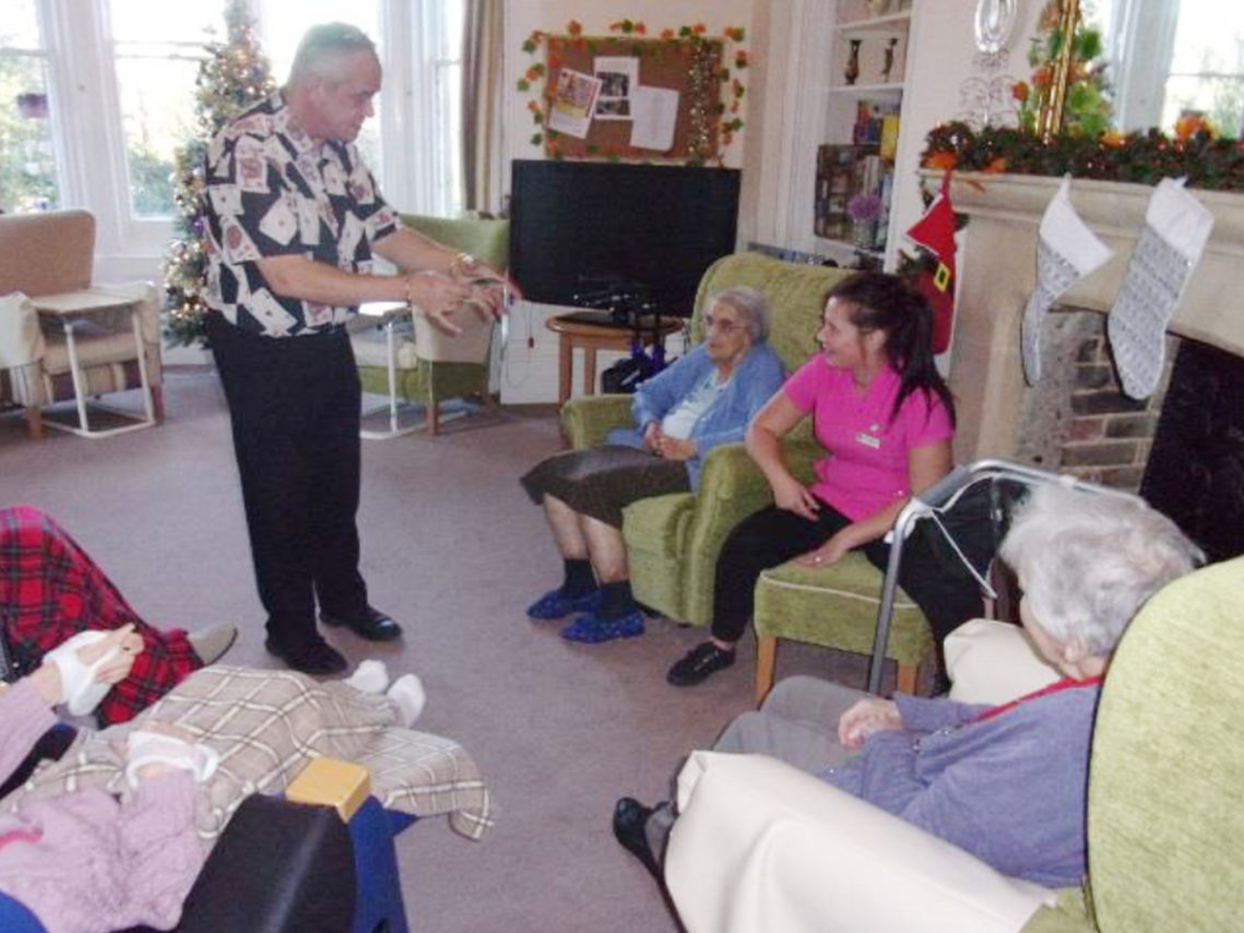 Mark the magician performing magic to residents at Loose Valley Care Home