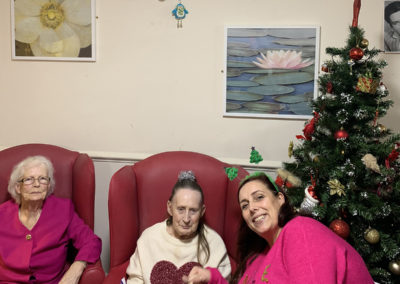Staff and residents in sparkly clothes at the Lulworth House Christmas Party