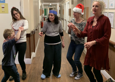 Residents and families dancing in the corridors at the Lulworth House Christmas Party