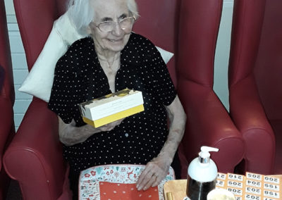 A Lulworth House residents smiling at receiving a box of chocolates